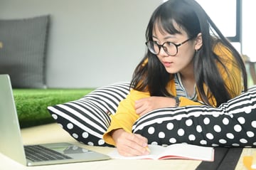 teenage-female-student-sleep-on-pillows-read-book-GSJ9NDC-min