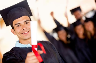 Happy male graduate holding his diploma and smiling