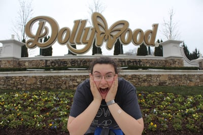 Lexi in front of Dollywood sign with excited look on face