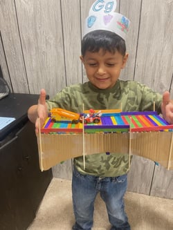 PA Virtual cyber student holding colorful homemade bridge