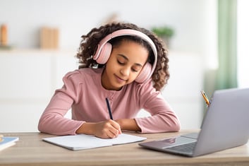 auditory-learner-girl-headset-taking-notes