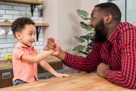 black-father-son-arm-wrestling